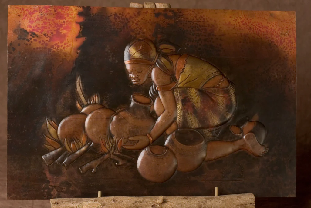 A picture of Congo art of a woman kneeling with bowels